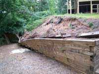 Failing treated timber wall Failing treated timber wall