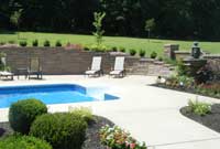 Backyard with pool with patterned retaining wall