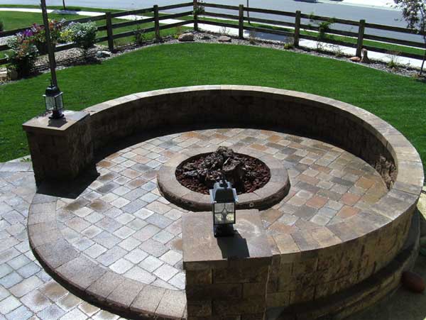 Raised patio with fire pit and seating wall Raised patio with fire pit and seating wall