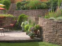 Backyard raised patio with stairs and terraces