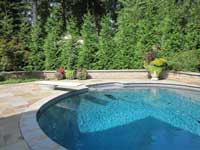 Below ground swimming pool with retaining wall Below ground swimming pool with retaining wall