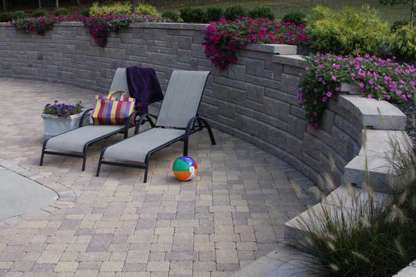 Backyard with pool with patterned retaining wall