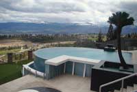 Above ground swimming pool with retaining wall